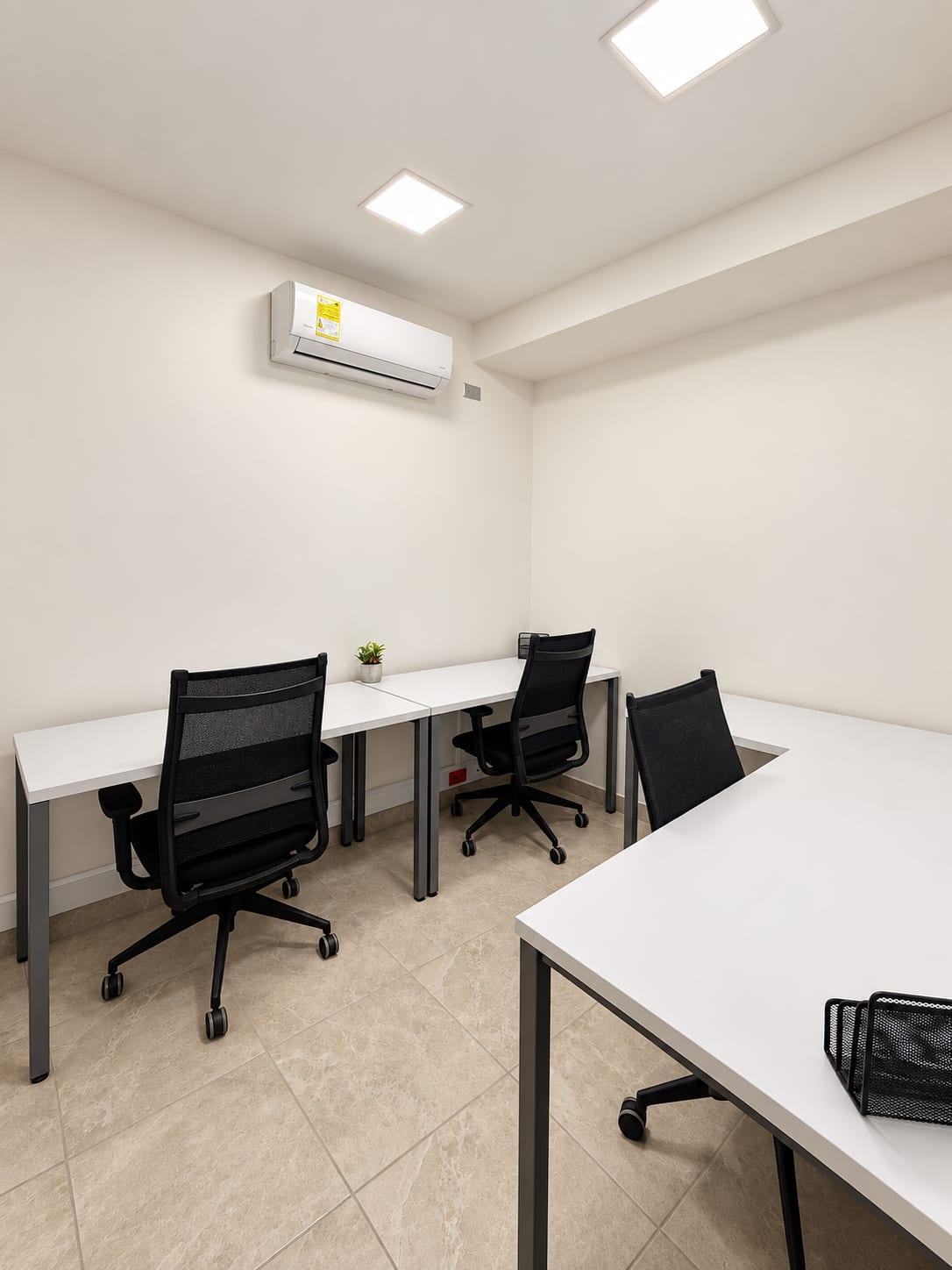 Private office with white desks and ergonomic chairs